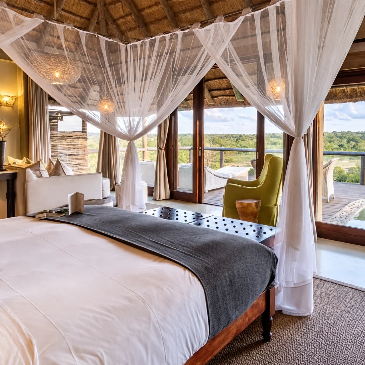 White mosquito netting draped above a bed with a view onto a lodge deck.
